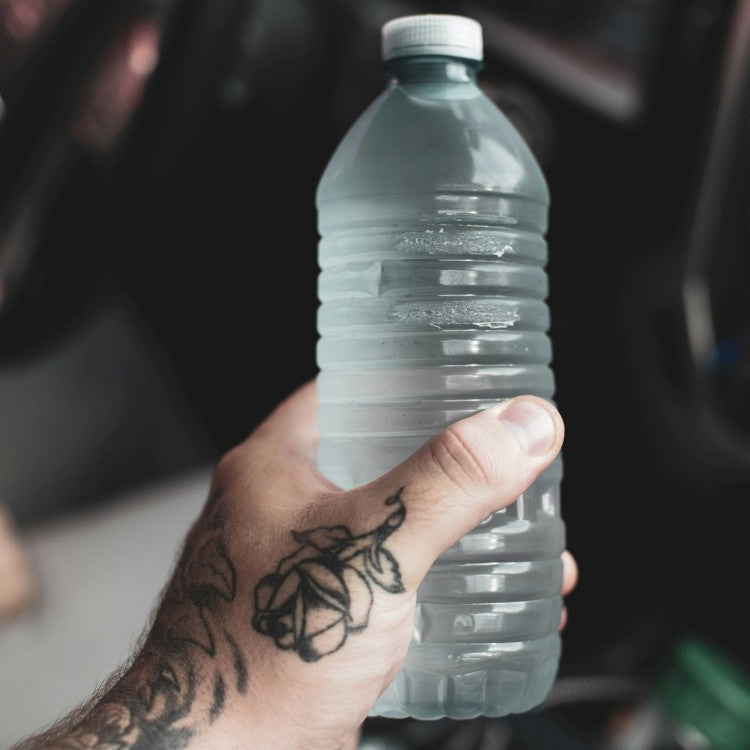 hand holding a bottle of water