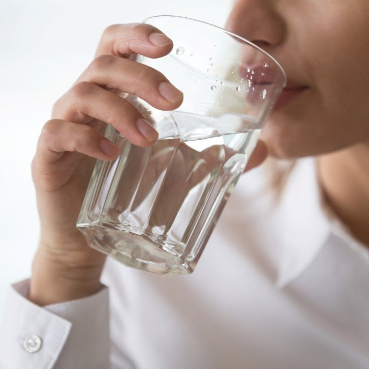 person drinking glass of water
