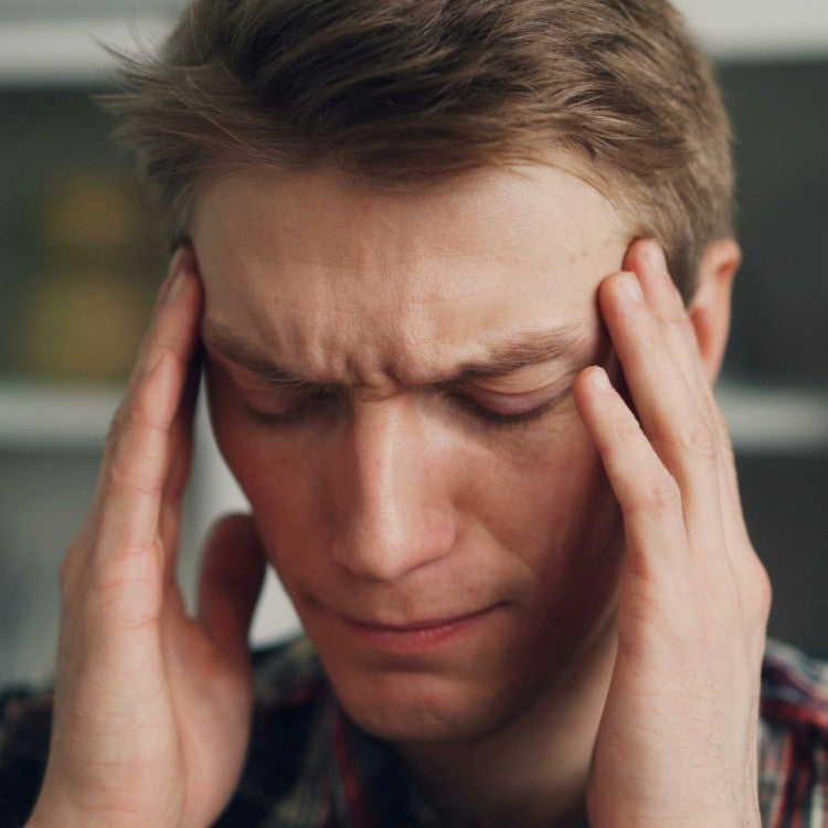 man holding head in hands