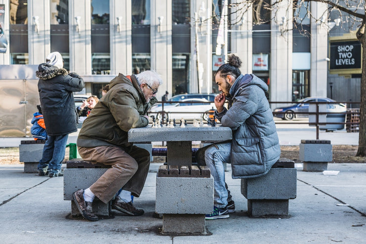 young man and old man play chess