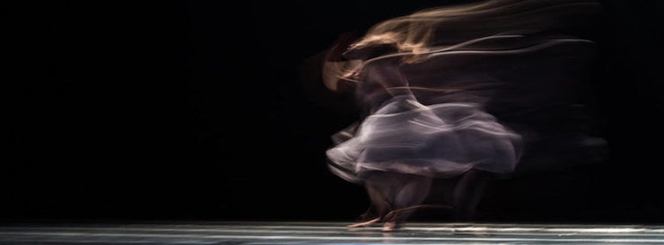 image of a twirling female, blurred from movement