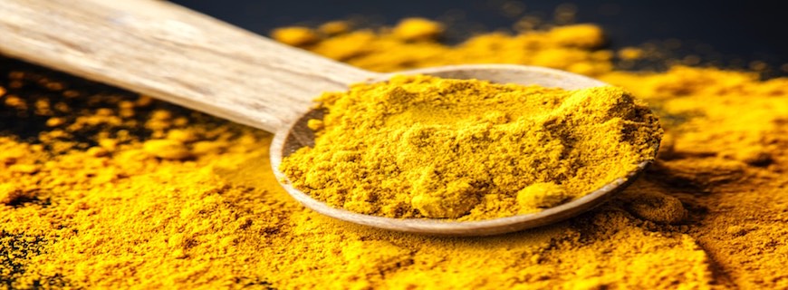 image of turmeric on wooden spoon