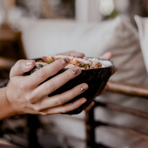 person holding bowl of porridge