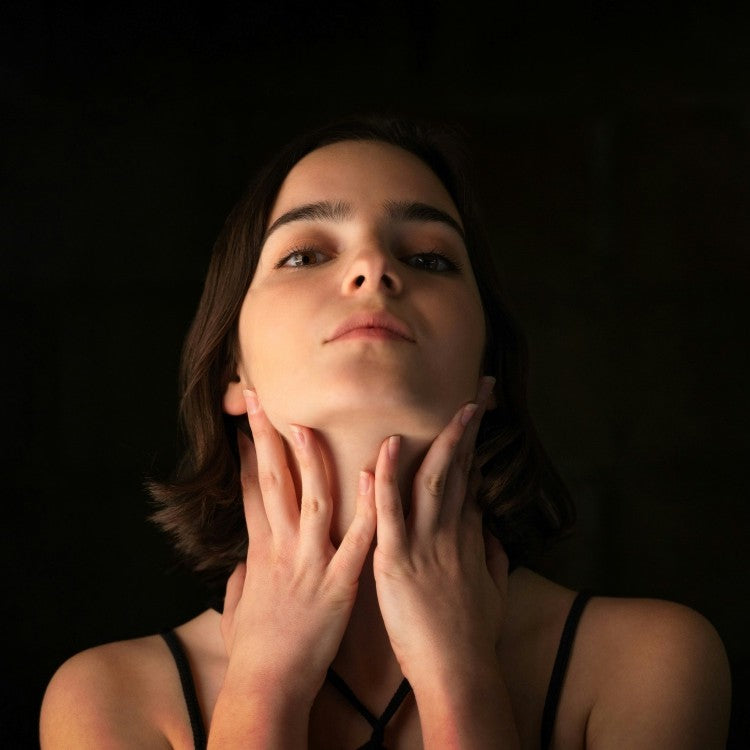 woman holding throat