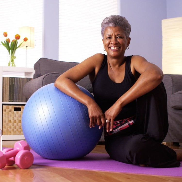 woman with pilates ball and weights