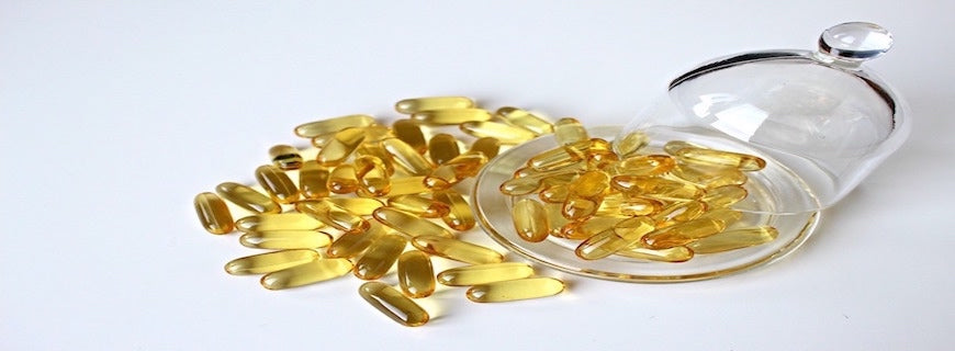 fish oil capsules spillling out of bottle