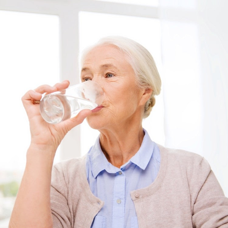 woman drinking water from glass