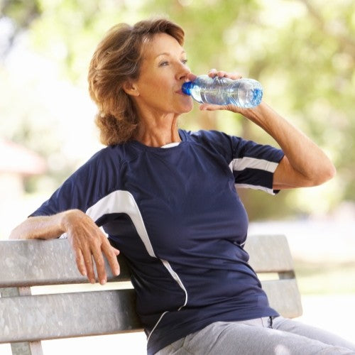 woman drinking a bottle of water