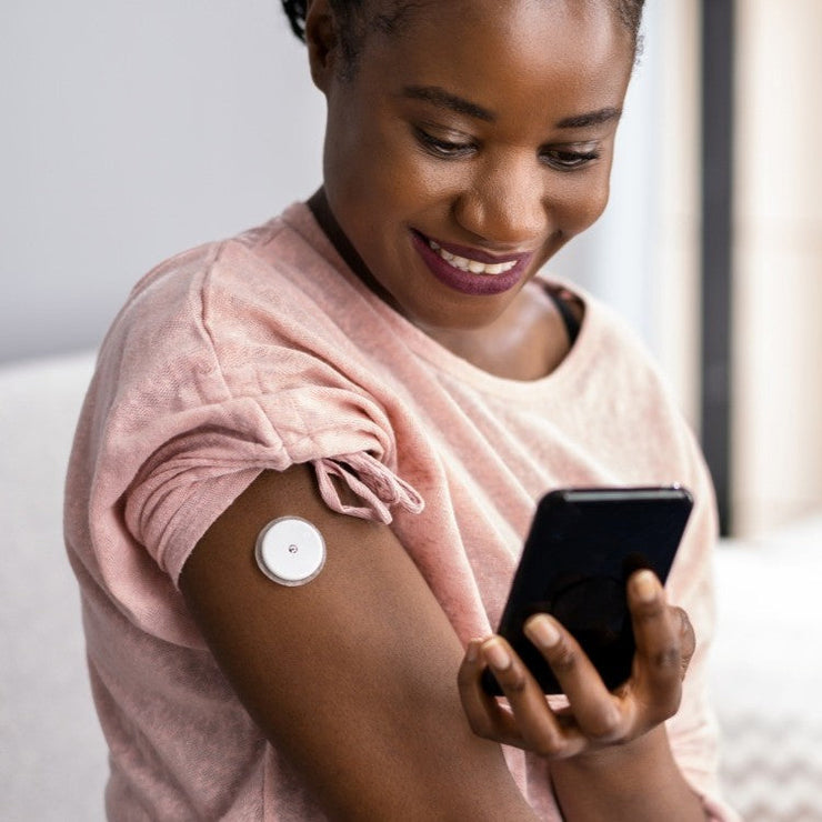 woman wearing a glucose monitor