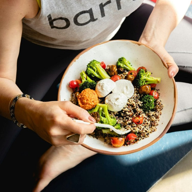 person eating bowl of healthy food