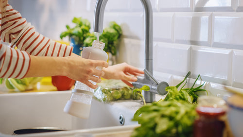 filling up bottle from water tap
