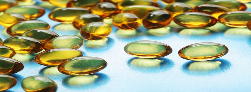 Omega-3 fish oil capsules on blue surface