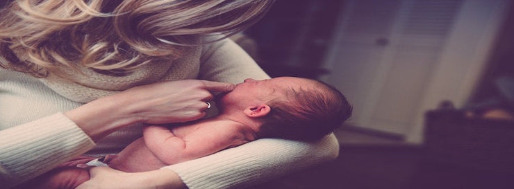 mother cradling infant baby