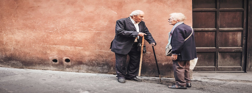 elderly man speaking to old woman