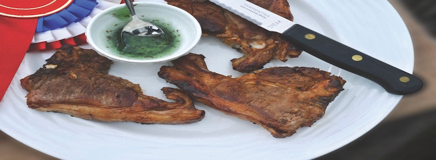 fried meat slices on plate with dip and knife