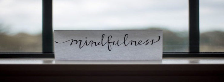 the word 'mindfulness' written on a sheaf of paper