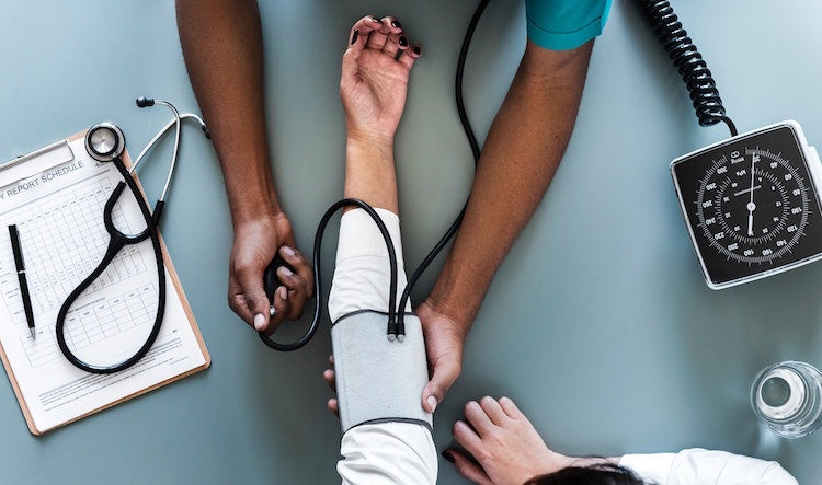 Image of man having blood pressure tested