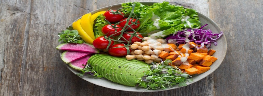 salad bowl containing lettuce, tomato, avocado, chickpeas
