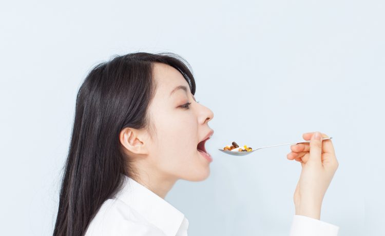woman putting a spoonful of food in mouth
