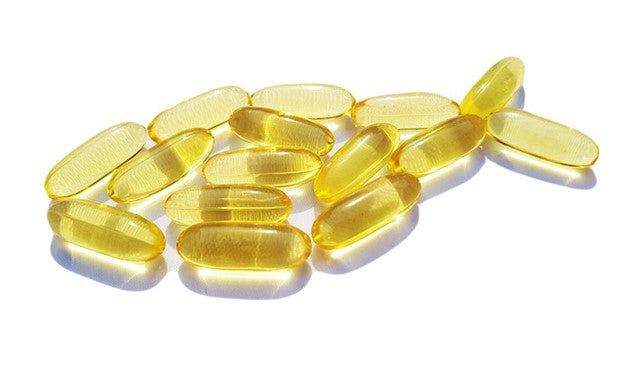 Fish Oil capsules arranged in the shape of a fish