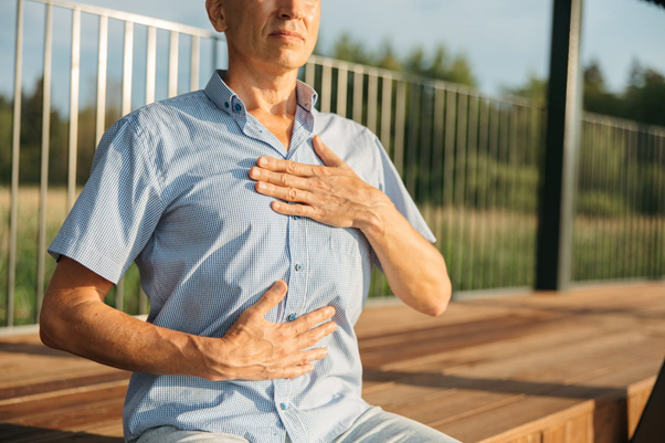 person with hands on chest and stomach