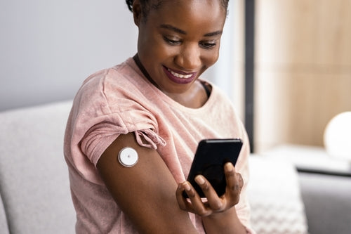 woman wearing a glucose monitor