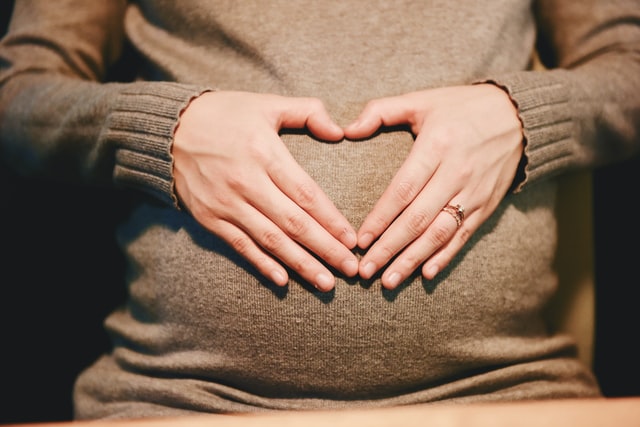 pregant woman with hands on stomach