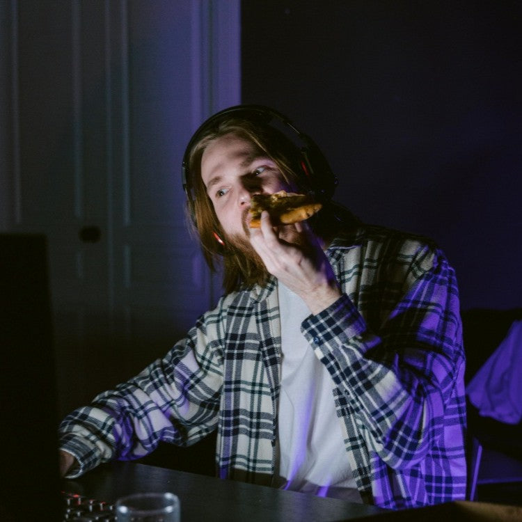 man eating in the dark