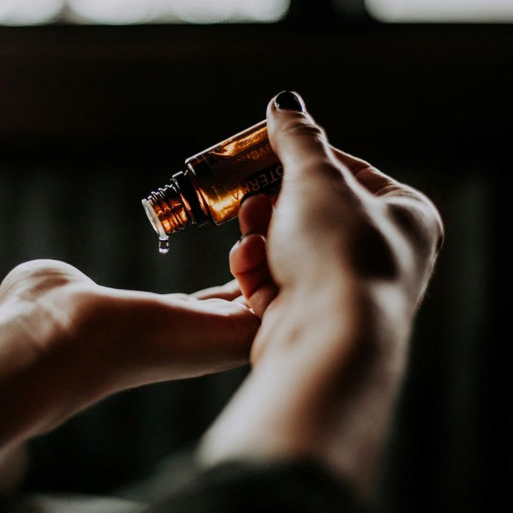 person applying oil to hand