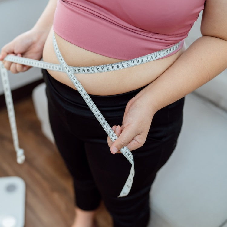 person measuring waist