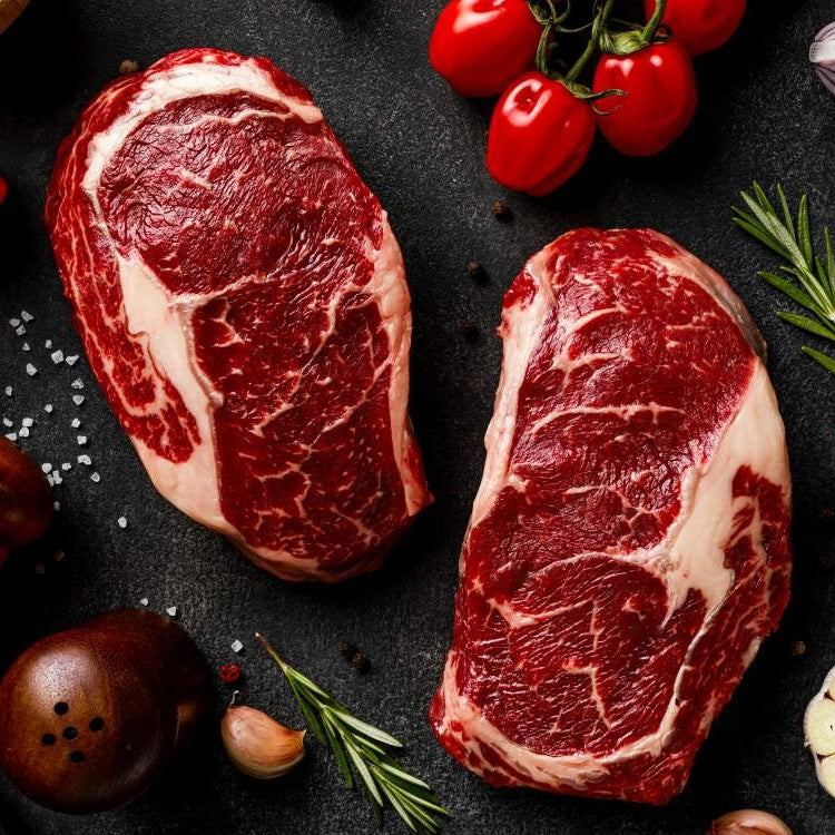 two uncooked steaks