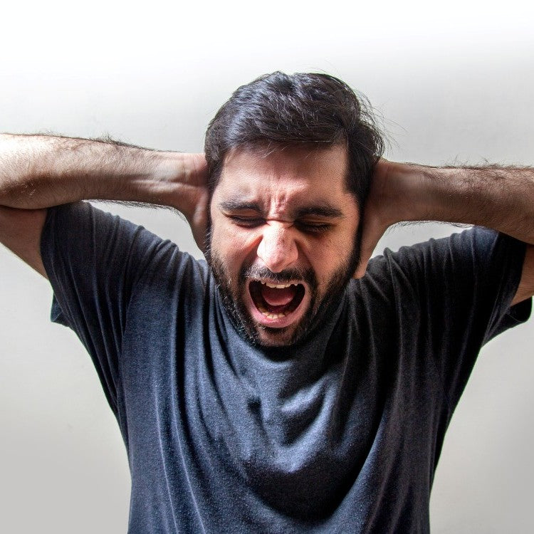 man holding ears and shouting