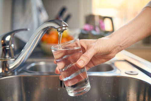 glass of water filling from tap