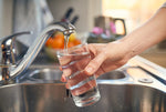 filling glass of water from tap