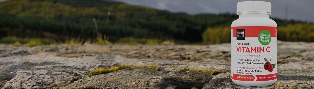 bottle of Vibrant Health Vitamin C capsules on outdoor background