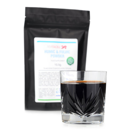 packet of humic and fulvic powder sachets and glass of powder with water
